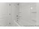 Clean, new bathtub and shower combo featuring built-in shelving and a shower head at 46 N District Ave # 251, Clayton, NC 27527