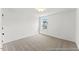 Bright bedroom with neutral carpet, a window, and ample natural light at 46 N District Ave # 251, Clayton, NC 27527