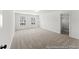 Expansive main bedroom featuring neutral carpet, dual windows, and ample closet space at 46 N District Ave # 251, Clayton, NC 27527