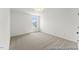 Cozy bedroom with neutral carpet, a window, and ample natural light at 46 N District Ave # 251, Clayton, NC 27527