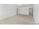 Large bedroom featuring neutral carpet, ample space, and a modern light fixture at 46 N District Ave # 251, Clayton, NC 27527