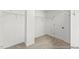 Walk-in closet featuring wire shelving, neutral carpet, and a door for privacy at 46 N District Ave # 251, Clayton, NC 27527