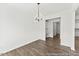 Dining area with modern chandelier, desk nook, and hardwood floors at 46 N District Ave # 251, Clayton, NC 27527