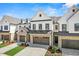 Attractive townhome with two-car garage, brick accents, and landscaping, offering curb appeal at 46 N District Ave # 251, Clayton, NC 27527