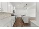 Stylish kitchen with white cabinets, stainless steel appliances, and a herringbone backsplash at 46 N District Ave # 251, Clayton, NC 27527