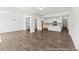 Inviting living area with hardwood floors, open layout, and seamless flow to kitchen at 46 N District Ave # 251, Clayton, NC 27527