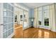 Bright living room featuring French doors, light blue walls, and hardwood floors at 509 Loblolly Dr, Durham, NC 27712