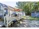 Spacious backyard with a deck, table, grill, and a storage shed at 5108 Walton Hill Rd, Knightdale, NC 27545