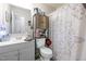 Well-lit bathroom with a toilet, vanity, mirror, and cabinet at 5108 Walton Hill Rd, Knightdale, NC 27545