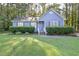 Charming blue home with a well-manicured front lawn and lush green landscaping at 5108 Walton Hill Rd, Knightdale, NC 27545