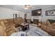 Spacious living room with fireplace, large TV, and access to the dining area at 5108 Walton Hill Rd, Knightdale, NC 27545