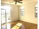 A sunlit bedroom featuring a ceiling fan, hardwood floors, and a sliding glass door at 51207 Eastchurch, Chapel Hill, NC 27517