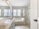 Well-lit bathroom with a soaking tub, separate shower, and double vanity at 5317 Tifton Dr, Raleigh, NC 27610