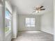 Bright bedroom with neutral walls and carpet, featuring a ceiling fan and multiple windows for great lighting at 5317 Tifton Dr, Raleigh, NC 27610
