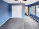 This blue bedroom has a ceiling fan and neutral carpet at 5317 Tifton Dr, Raleigh, NC 27610