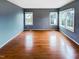 This spacious bedroom features hardwood floors, neutral walls, bright windows and white trim at 5317 Tifton Dr, Raleigh, NC 27610