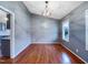 This dining room features hardwood floors, neutral walls, and a modern light fixture at 5317 Tifton Dr, Raleigh, NC 27610