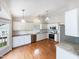 Modern kitchen with stainless steel appliances, granite countertops, hardwood floors, and stylish pendant lighting at 5317 Tifton Dr, Raleigh, NC 27610