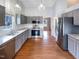 This spacious kitchen boasts gray cabinets, stainless steel appliances, and hardwood floors at 5317 Tifton Dr, Raleigh, NC 27610