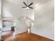 Bright living room showcasing vaulted ceilings, hardwood floors, and an open layout leading to a modern kitchen at 5317 Tifton Dr, Raleigh, NC 27610