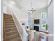 Bright living room with soaring ceilings, a fireplace, large windows, and elegant furnishings at 5317 Tifton Dr, Raleigh, NC 27610
