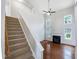 Bright living room with soaring ceilings and fireplace; stairs lead to upper level at 5317 Tifton Dr, Raleigh, NC 27610