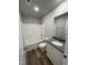 Bathroom featuring a granite vanity, wood-look floor, and shower-tub combination at 57 Faucette Dr, Selma, NC 27576