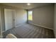 Bedroom featuring neutral walls, carpet flooring, a window for natural light, and a closet door at 57 Faucette Dr, Selma, NC 27576