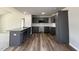 Modern kitchen featuring dark cabinets, stainless steel appliances, and granite countertops, perfect for cooking enthusiasts at 57 Faucette Dr, Selma, NC 27576