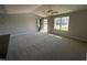 Bright living room with neutral walls, vaulted ceiling, ceiling fan and large windows, offering a welcoming space at 57 Faucette Dr, Selma, NC 27576