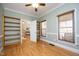 Bright bedroom features wooden floors, chair railing and built-in bookshelves at 6005 Kim'S Dr, Hurdle Mills, NC 27541