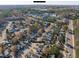 Community aerial with lake, tree-lined streets, homes, downtown Durham skyline and property address at 605 Stratton Way, Durham, NC 27704