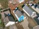 Aerial shot showcasing the blue two-story home including its driveway, surrounding yard, and neighboring houses at 605 Stratton Way, Durham, NC 27704