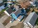 Aerial view of a blue two-story house with a driveway and a fenced yard showcasing its position within the neighborhood at 605 Stratton Way, Durham, NC 27704