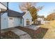 View of the light blue siding of the home exterior and small concrete patio in the backyard at 605 Stratton Way, Durham, NC 27704