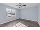 Bright bedroom with herringbone flooring, a modern ceiling fan, and natural light at 605 Stratton Way, Durham, NC 27704