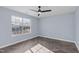 Bright bedroom with herringbone flooring, a modern ceiling fan, and natural light at 605 Stratton Way, Durham, NC 27704