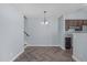 Dining room featuring herringbone floors, a modern light fixture, and kitchen access at 605 Stratton Way, Durham, NC 27704