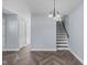 Dining area with stairs, modern lighting, and neutral walls, creating a welcoming space at 605 Stratton Way, Durham, NC 27704