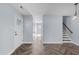 Hallway features stylish herringbone floors, leading to stairs and a bright entry door at 605 Stratton Way, Durham, NC 27704