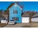 The exterior of the home has blue siding, black shutters, and an attached garage at 605 Stratton Way, Durham, NC 27704