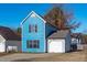 The exterior of the home has blue siding, black shutters, and an attached garage at 605 Stratton Way, Durham, NC 27704