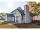 The exterior of the home includes a chimney, sliding glass door, small patio, and light blue siding at 605 Stratton Way, Durham, NC 27704
