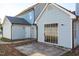 Exterior of the home with a small patio, doors, and light blue siding at 605 Stratton Way, Durham, NC 27704