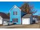The exterior of the home has blue siding, black shutters, and an attached garage at 605 Stratton Way, Durham, NC 27704