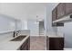 Modern kitchen boasts stainless steel appliances and beautiful countertops and stylish flooring at 605 Stratton Way, Durham, NC 27704