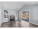 Cozy living room with a fireplace, sliding glass doors, and herringbone floors at 605 Stratton Way, Durham, NC 27704