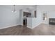 Open-concept living area featuring a fireplace, herringbone floors, and modern light fixture at 605 Stratton Way, Durham, NC 27704