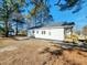 A spacious backyard with a newly installed concrete patio, freshly planted landscaping at 606 E Pearsall St, Dunn, NC 28334