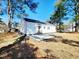 A tree filled backyard with a concrete patio at 606 E Pearsall St, Dunn, NC 28334